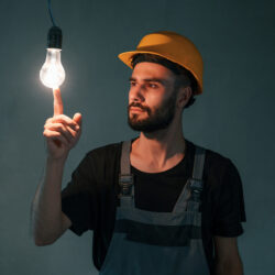 Light bulb in the dark room. The man is making repairs in the apartment.